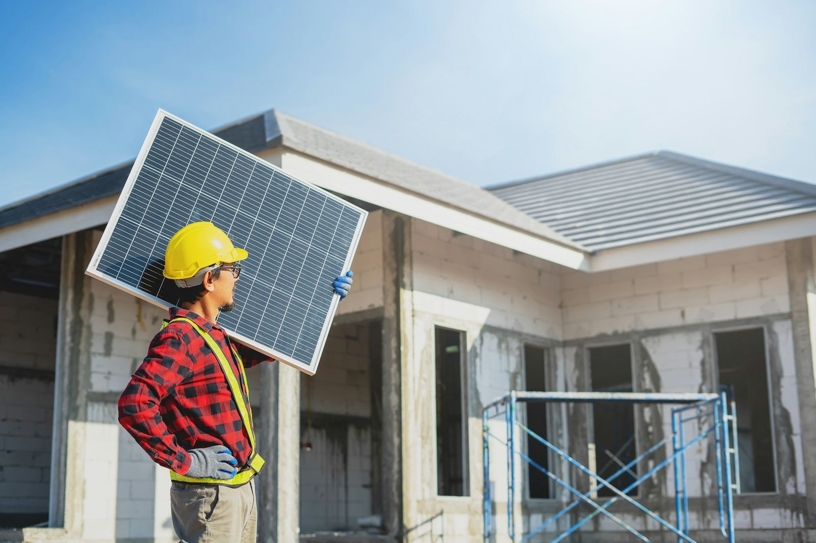 An installer carrying a solar module on site